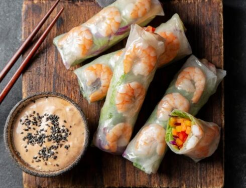 Vietnamese spring rolls with chopsticks and a miniature bowl filled with sauce