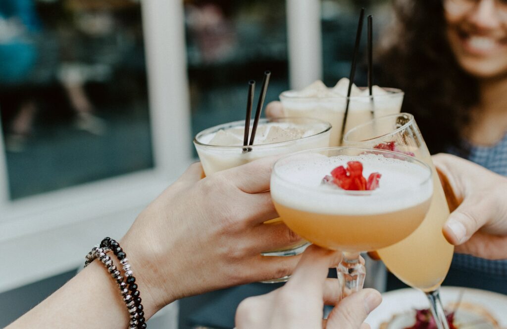 girls holding cocktails in their hands